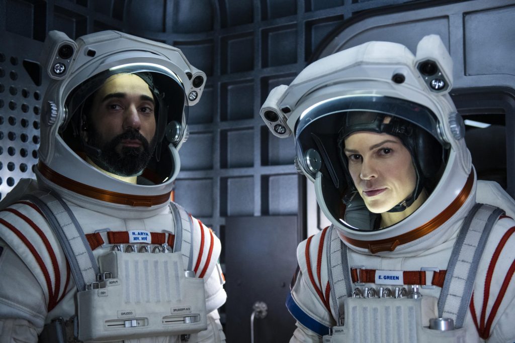 AWAY (L to R) RAY PANTHAKI as RAM ARYA and HILARY SWANK as EMMA GREEN, in episode 109 of AWAY. Cr. DIYAH PERA/NETFLIX © 2020